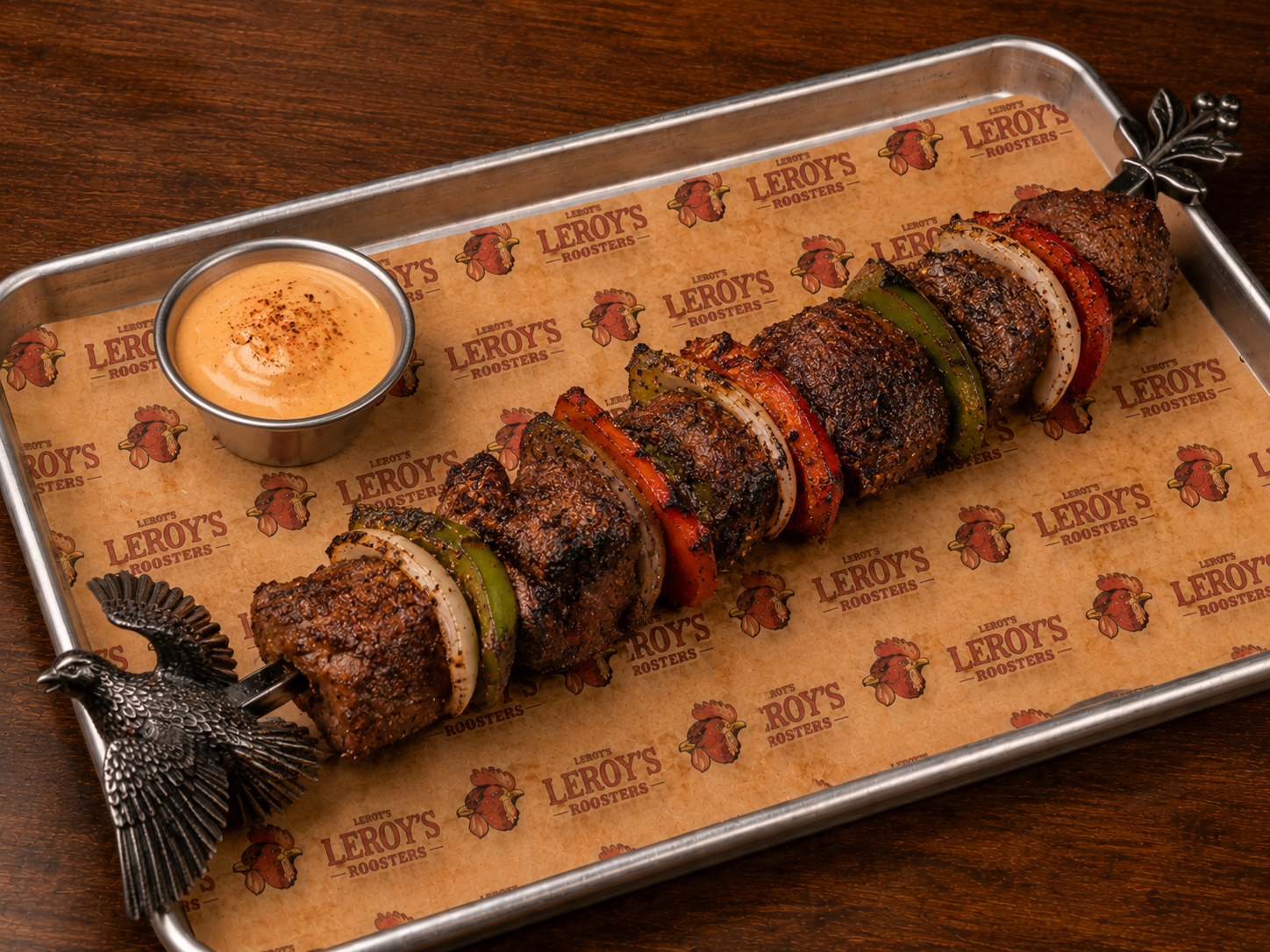 House Grouse kabob on a tray with sauce